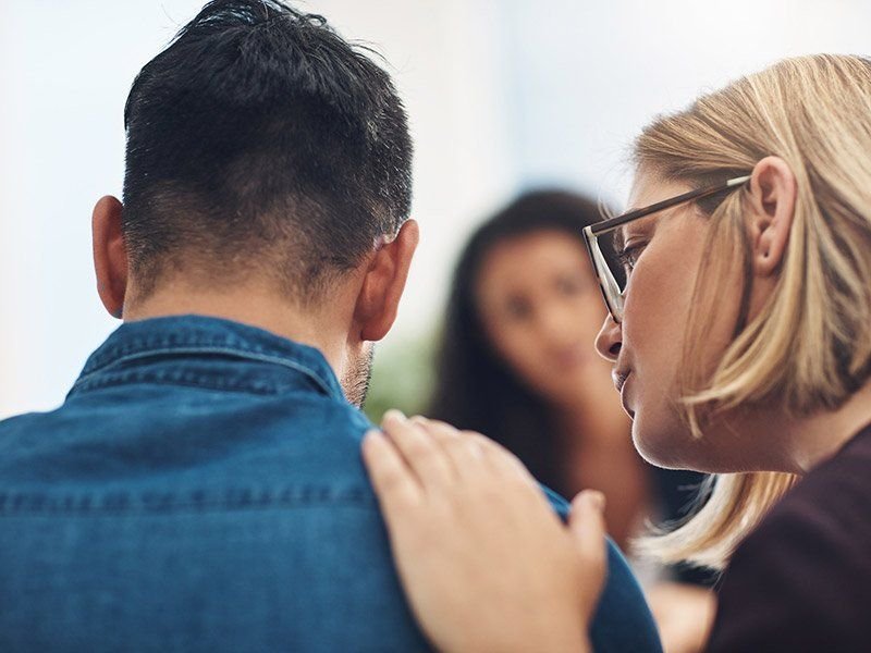 Solicitor comforting a client