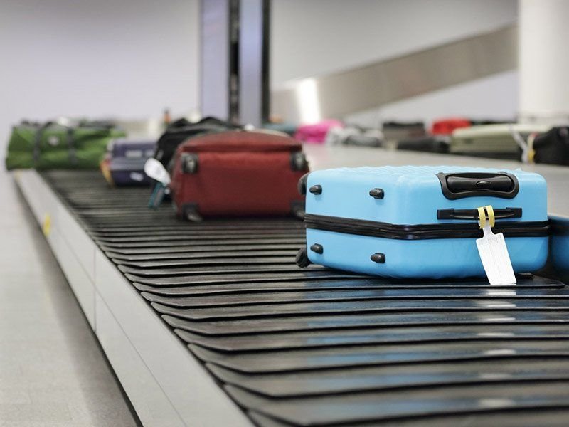 Suitcases on an airport luggage carousel
